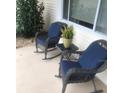 Relaxing front porch with cushioned rocking chairs, side table, and view of the neighborhood at 10839 Sw 78Th Ct, Ocala, FL 34476