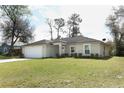 Charming single-story home with a well-manicured lawn and attached two car garage at 1090 Parnell Ct, Deltona, FL 32738