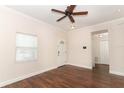 Bright living room features hardwood floors and views into the foyer and a closet at 1090 Parnell Ct, Deltona, FL 32738