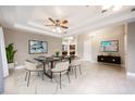 Elegant dining room boasting a modern chandelier, neutral decor, and a view into the kitchen at 113 Rockhill Dr, Sanford, FL 32771