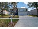 Inviting two-story home boasts a three-car garage, large windows, and a well-kept lawn at 1262 Stonewater Cir, Ocoee, FL 34761