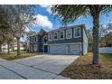 Attractive two-story home with a three-car garage, arched window, and inviting curb appeal at 1262 Stonewater Cir, Ocoee, FL 34761