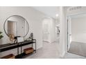 Open foyer with tile floors, a modern console table, and neutral decor at 150 Amberwood Way, Umatilla, FL 32784