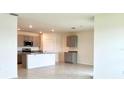 Modern kitchen with an island, gray cabinets, stainless steel appliances, and tile floors at 2877 Sunridge Loop, St Cloud, FL 34771