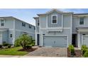 Charming two-story home with light blue siding, a one-car garage, and a well-manicured front yard at 2916 Satire St, Kissimmee, FL 34746