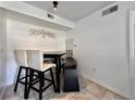 Cozy dining area with tile flooring, a dark wood table, and a mix of chairs and bench seating at 3016 Parkway Blvd # 110, Kissimmee, FL 34747