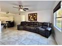 Living room with tile flooring, modern ceiling fan, and a reclining sofa with drink holders at 3016 Parkway Blvd # 110, Kissimmee, FL 34747