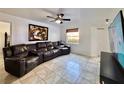 Bright living room featuring tile floors, a contemporary ceiling fan, and a large reclining sofa at 3016 Parkway Blvd # 110, Kissimmee, FL 34747