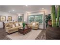 Cozy living room with neutral tones, wood floors, and lots of natural light at 421 W Ariel Rd, Edgewater, FL 32141