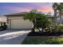 Charming single-story home with a large two-car garage and a beautifully paved driveway at 569 Vista Sol Dr, Davenport, FL 33837
