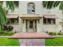 Inviting home featuring a decorative brick entrance, arched windows, and neutral awnings at 613 E Ridgewood St # 5, Orlando, FL 32803