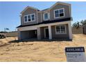 New construction home with gray siding and a two-car garage in a developing community at 726 Pointe Emerson Blvd, Apopka, FL 32703