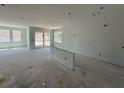 Bright, spacious living room with unfinished floors featuring a sliding glass door and large windows at 726 Pointe Emerson Blvd, Apopka, FL 32703