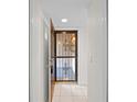 The open, secured front door reveals a bright, tiled entryway, inviting you into the home at 940 Douglas Ave # 132, Altamonte Springs, FL 32714