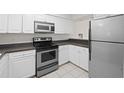 Efficient kitchen with stainless steel appliances, white cabinets, and light countertops at 940 Douglas Ave # 132, Altamonte Springs, FL 32714