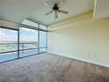 This well-lit bedroom includes carpeting and a large window showcasing neighborhood views at 101 S Eola Dr # 1009, Orlando, FL 32801