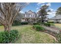 Charming two-story home with inviting front porch and meticulously maintained lawn and gardens at 10384 Se 41St Ter, Belleview, FL 34420