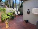 Cozy red brick patio featuring a seating area, lush plants, and privacy fence at 1200 Winterberry Lane, Fern Park, FL 32730