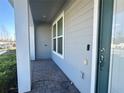 The walkway to the front door with grey siding and white columns at 14388 Orchild Island Dr, Orlando, FL 32827