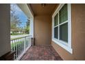 Welcoming front porch features brick flooring, white railings, and a cozy spot to enjoy the neighborhood views at 15574 Murcott Blossom Blvd, Winter Garden, FL 34787