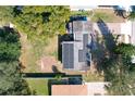 Aerial view of the house with a flat roof featuring solar panels and a spacious backyard at 1816 Jasper Drive, Orlando, FL 32807