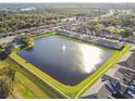 Beautiful aerial view of a tranquil community lake with fountain and surrounding homes at 1821 Christina Lee Ln, St Cloud, FL 34769