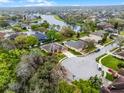 Aerial view of the home, showcasing the surrounding community, trees, nearby lake, and verdant landscaping at 2137 Blackjack Oak St, Ocoee, FL 34761