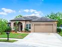 Attractive single-story home with lush landscaping, a neutral color palette, and a convenient two-car garage at 2137 Blackjack Oak St, Ocoee, FL 34761