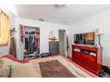 Bright bedroom featuring a closet and a dresser with television at 2413 Spingarn Ct, Orlando, FL 32811