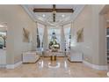 Elegant living room features high ceilings, decorative trim and gold accents, and natural lighting at 3037 Seigneury Dr, Windermere, FL 34786