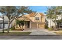 Inviting two-story home with a covered porch, manicured landscaping, and an attached two-car garage at 4019 Alcott Cir, Orlando, FL 32828