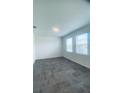 Bright bedroom with tile floors, two windows offering ample natural light and backyard views at 5960 Vision Rd, St Cloud, FL 34771