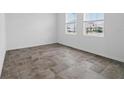 Bright, airy bedroom features a spacious open floor plan with tile flooring and natural light at 5960 Vision Rd, St Cloud, FL 34771