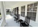 Inviting front porch featuring classic rocking chairs and ample space for relaxing at 610 Nadina Pl, Celebration, FL 34747