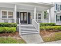 View of the front entrance of this well-maintained house with landscaping and stairs at 610 Nadina Pl, Celebration, FL 34747