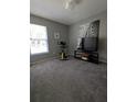 Cozy bedroom with plush carpeting, filled with an exercise machine, and a modern television at 680 Caribou Ct, Apopka, FL 32703