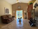 Inviting living room showcasing vaulted ceilings and access to the backyard at 680 Caribou Ct, Apopka, FL 32703