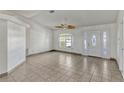 Spacious living room featuring tile flooring and decorative leaded glass front door and sidelights at 700 Roby Ct, Dundee, FL 33838