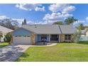 Charming single-story home featuring brick accents, a well-manicured lawn, and a two-car garage at 9532 Bay Vista Estates Blvd # 1, Orlando, FL 32836