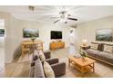 Bright living room with modern decor, tile floor, ceiling fan and comfortable seating at 996 E Normandy Blvd, Deltona, FL 32725