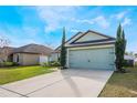 Charming home with a well-manicured front lawn and a two-car garage at 1230 Woodlark Dr, Haines City, FL 33844