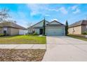 Charming home with a well-manicured front lawn and a spacious driveway at 1230 Woodlark Dr, Haines City, FL 33844