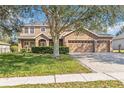 Beautiful two-story home with a three-car garage, paver driveway, and well-maintained landscaping at 1037 Truffles Ct, Apopka, FL 32712