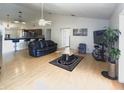 Spacious living room featuring an open floor plan, modern ceiling fan, and stylish furniture arrangement at 12017 Fambridge, Orlando, FL 32837