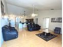 Bright living room featuring an open floor plan, modern ceiling fan, and stylish furniture arrangement at 12017 Fambridge, Orlando, FL 32837
