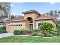 Charming single-story home with arched entryway, well-maintained landscaping and two car garage at 1314 Chessington Cir, Lake Mary, FL 32746