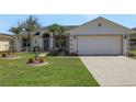 Beautiful single Gathering home with a two car garage and immaculately kept front lawn with palm trees at 1646 Arash Cir, Port Orange, FL 32128