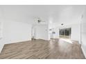 Bright living room boasts new wood-look flooring and a seamless flow into other living spaces at 1866 Matterhorn Dr, Orlando, FL 32818