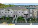 Aerial shot showcasing the modern townhome development with lush landscaping and convenient street access at 2945 Simile St, Kissimmee, FL 34746