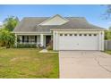 Charming single-story home with a well-maintained lawn and attached two-car garage in a quiet neighborhood at 3304 Kelsey Ln, St Cloud, FL 34772